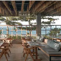 Suasana Bersantap dengan Pemandangan Laut, Pantai, dan Hidangan Lezat di Bayside Restaurant & Bar amber Lombok Beach Resort.