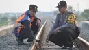 Petugas gabungan dari Polsuska dan Babinkamtibmas Kemijen Semarang  baut rel api di Jalur Kemijen, Minggu (3/6). Pemeriksaan dilakukan secara ketat dan berkala untuk keamanan jalur kereta api selama arus mudik 2018. (Liputan6.com/Gholib)