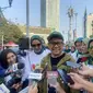 Wakil Ketua DPR Muhaimin Iskandar alias Cak Imin ikut menyosialisasi UU Nomor 4 tahun 2024 tentang Kesejahteraan Ibu dan Anak (KIA) di kawasan CFD Jakarta, Minggu (21/7/2024). (Liputan6.com/ Muhammad Radityo Priyasmoro)