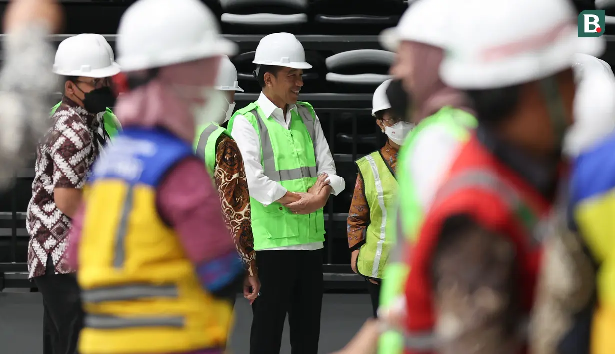 Presiden RI, Joko Widodo berbincang dengan para Menteri yang hadir saat meninjau fasilitas yang ada di Indoor Multifunction Stadium di Kompleks Gelora Bung Karno, Senayan, Jakarta, Jumat (13/1/2023) sore WIB. (Bola.com/Abdul Aziz)