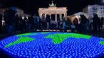 Sejumlah lilin dinyalakan dan dibentuk seperti dunia sebelumnya aksi Earth Hour Internasional di Berlin, Jerman (25/3). Kegiatan ini dilakukan dalam rangka memperingati hari bumi atau lebih dikenal dengan Earth Hour ke-10 atau 2017. (AFP/dpa/Paul Zinken)