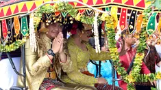 Pasangan Kahiyang Ayu Siregar dan Bobby Nasution menyapa warga saat kirab resepsi pernikahan Kahiyang Ayu-Bobby Nasution di Kota Medan, Sumatera Utara, Minggu (26/11). (Liputan6.com/Johan Tallo)