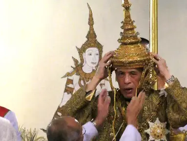 Maha Vajiralongkorn mengenakan mahkota ketika dinobatkan sebagai Raja Thailand dengan gelar Rama X dari Dinasti Chakri di Istana Negara, Bangkok, Sabtu (4/5/2019). Upacara penobatan ini akan berlangsung hingga Senin, 6 Mei 2019. (Photo by Thai TV Pool /Thai Tv Pool/AFP)