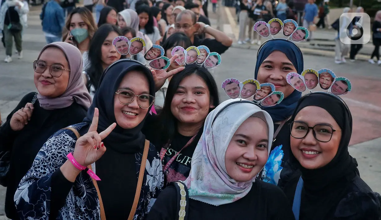 Penggemar Westlife berpose saat tiba untuk menonton konser bertajuk 'The Wild Dreams Tour 2023' di kawasan Stadion Utama Gelora Bung Karno Sabtu (11/2/2023). Boyband Irlandia itu sebelumnya telah manggung di berbagai kota sejak 2022, mulai dari Yogyakarta, Bogor, Surabaya, hingga di Tangerang beberapa hari lalu. (Liputan6.com/Angga Yuniar)