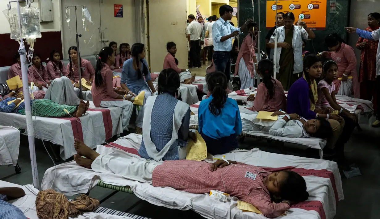 Sejumlah siswi dirawat di rumah sakit menyusul kebocoran gas dari sebuah depot kontainer di New Delhi, Sabtu (6/5). Lebih dari 100 siswa dilarikan ke rumah sakit, di antaranya menderita sesak napas, mual, iritasi mata bahkan pingsan. (Chandan KHANNA/AFP)