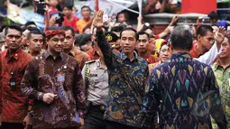 Presiden Jokowi melambaikan tangan kepada warga yang hadir di perayaan  Cap Go Meh di Kota Bogor, Jawa Barat, Kamis (5/3/2015). (Liputan6.com/Faizal Fanani)