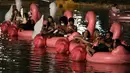 Orang-orang bersantai di atas balon flamingo saat mereka menonton film selama Festival Terapung pertama di Danau Sarah Kubstichek Brasilia, Brasil (30/9/2020). Brasil mengadakan festival pertama yang mengusung tema terapung. (AP Photo/Eraldo Peres)
