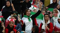 Perawat Iran Zahra Pashaei (tengah) bersorak saat menyaksikan laga kualifikasi Piala Dunia 2022 antara Iran dengan Kamboja di Stadion Azadi, Teheran, Iran, Kamis (10/10/2019). Pihak penyelenggara menyediakan tempat khusus di tribune untuk suporter wanita. (AP Photo/Vahid Salemi)