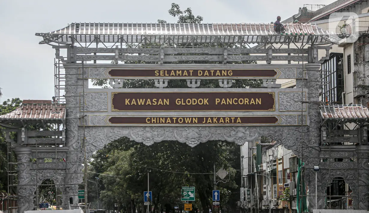 Sejumlah pekerja membangun gapura di Jalan Pancoran, Jakarta, Sabtu (11/6/2022). Pembangunan gapura tersebut bertujuan mempercantik kawasan Chinatown (Pecinan) Glodok Pancoran. (Liputan6.com/Faizal Fanani)