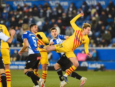 Gelandang Barcelona Frenkie De Jong (kanan) melonpat untuk mendapatkan bola saat melawan Deportivo Alaves dalam duel pekan ke-22 La Liga 2021/22, di Estadio Mendizorroza, Senin (24/1/2022) dini hari WIB. Gol telat Frenkie De Jong memenangkan Barcelona 1-0. (Ander GILLENEA / AFP)