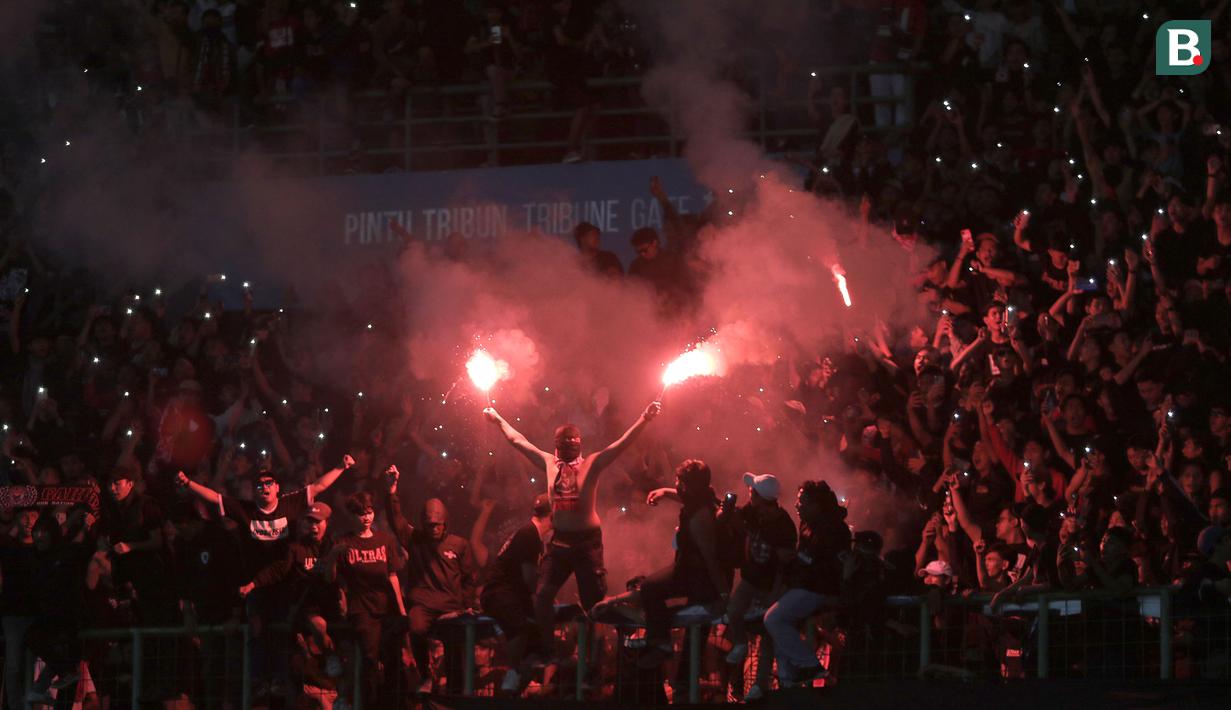 <p>Suporter Timnas Indonesia U-19 menyalakan suar&nbsp;saat laga Grup A Piala AFF U-19 2022 antara Timnas Indonesia U-19 melawan Timnas Vietnam U-19 di Stadion Patriot Candrabhaga, Bekasi, Jawa Barat, Sabtu (02/07/2022). (Bola.com/Ikhwan Yanuar)</p>