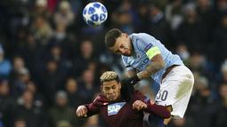 Bek Manchester City, Kyle Walker, duel udara dengan striker Hoffenheim, Joelinton, pada laga Liga Champions di Stadion Etihad, Rabu (12/12). Manchester City menang 2-1 atas Hoffenheim. (AP/Dave Thompson)