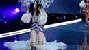 Model Tiongkok, Ming Xi terduduk di atas catwalk setelah jatuh tergelincir pada Victoria’s Secret Fashion Show 2017 di Shanghai, Senin (20/11). Ming yang mengenakan stiletto boots kemungkinan menginjak jubahnya sendiri yang panjang. (AP/Andy Wong)