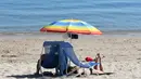 Wisatawan berjemur di pantai sambil menikmati matahari musim panas di Benodet, Prancis barat, Senin (19/6). Saat ini suhu temperatur di Prancis mencapai 36 derajat celcius. (AFP Photo / Fred TANNEAU)