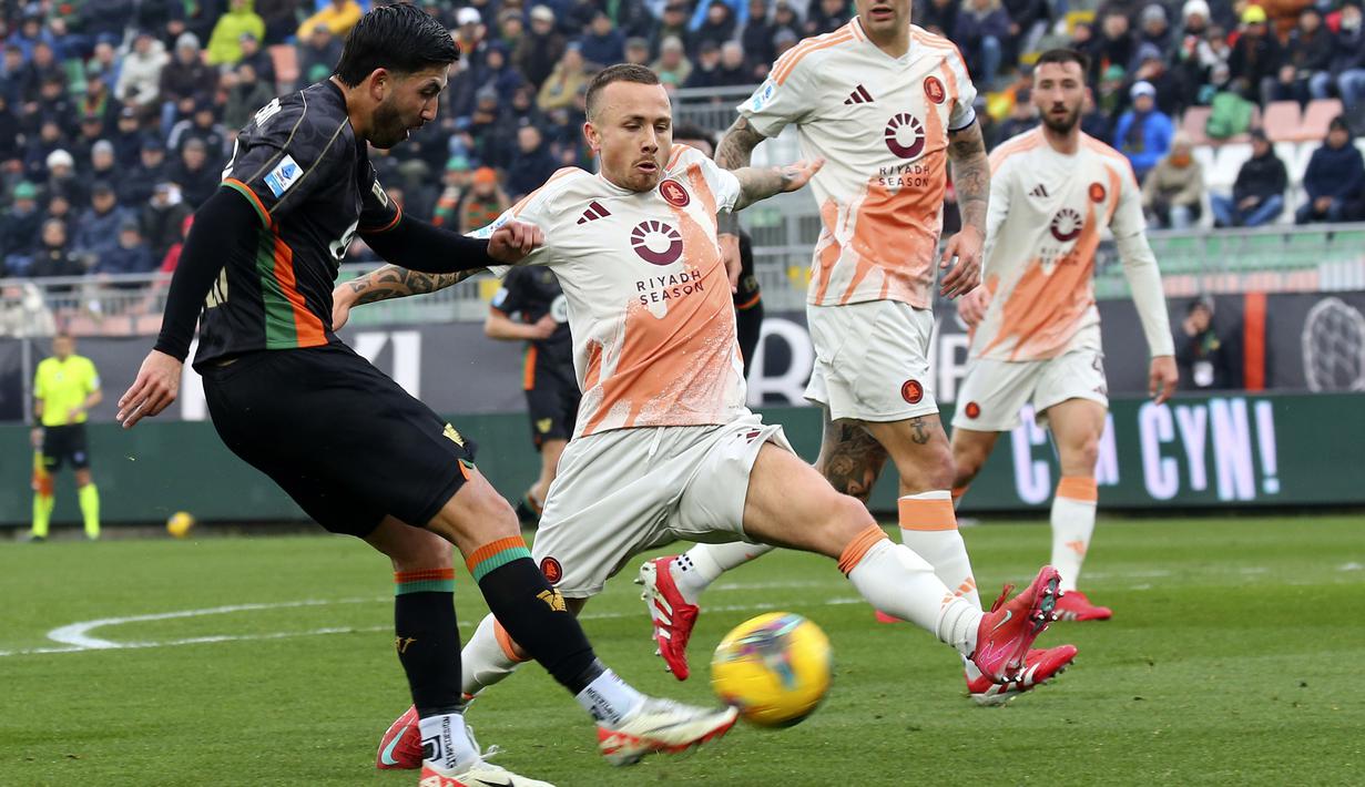 Pemain Venezia, Mikael Egill Ellertsson (kiri) berusaha melepaskan tembakan ke gawang AS Roma dalam laga lanjutan Liga Italia 2024/2025 di Pier Luigi Penzo Stadium, Venice, Italia, Minggu (10/02/2025). (AP Photo/LaPresse/Paola Garbuio)