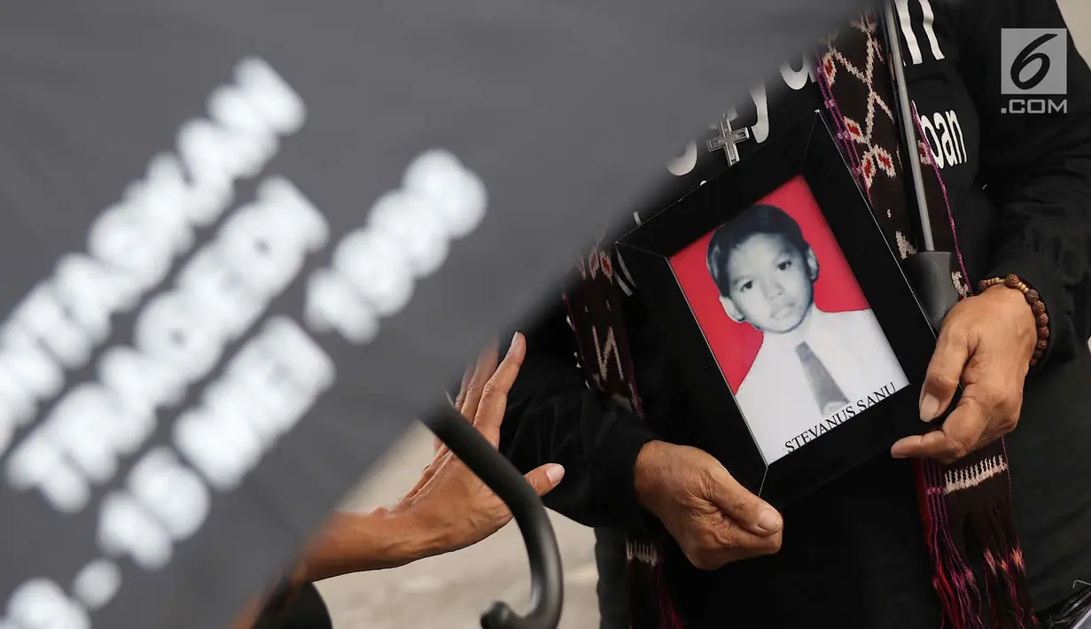 Aktivis membawa foto korban HAM saat aksi Kamisan ke-538 di depan Istana Negara, Jakarta, Kamis (17/5). Aksi Kamisan tersebut sekaligus memeringati 20 tahun reformasi. (Liputan6.com/Immanuel Antonius)