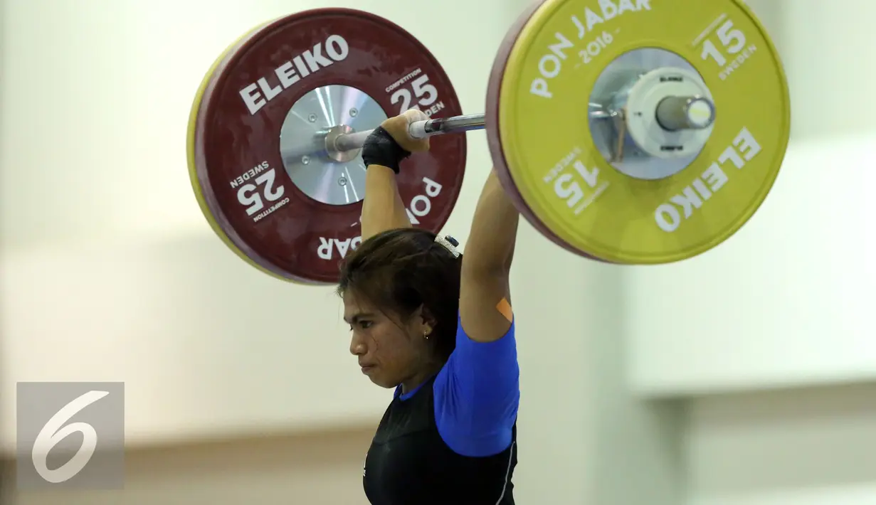 Lifter Jabar, Sri Wahyuni Agustiani saat mengangkat beban di kelas 48 kg PON XIX Jabar di Gelora Sabilulungan, Kab Bandung, Selasa (20/9). Total angkatan Sri Wahyuni 182 Kg sekaligus memecahkan rekor nasional. (Liputan6.com/Helmi Fithriansyah)