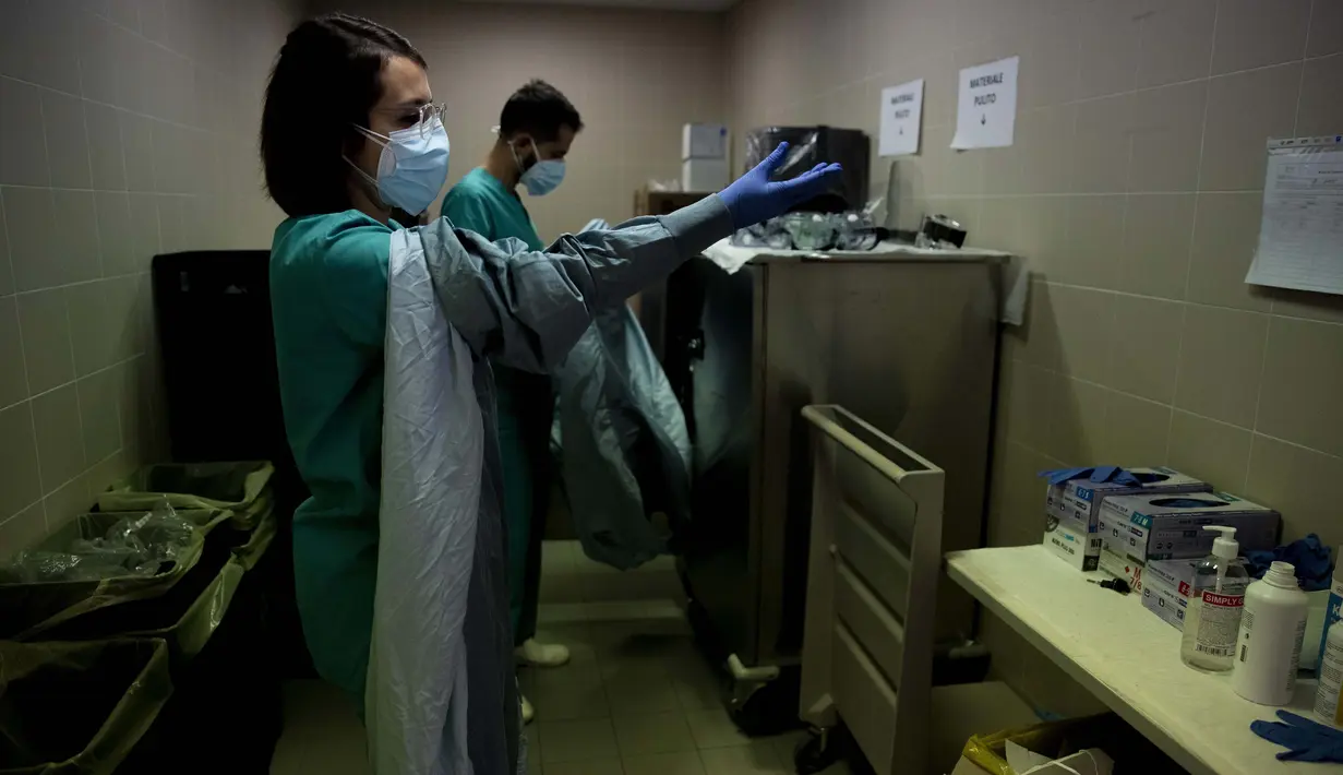 Dokter Elisabetta Teti dan Pier Giorgio Pace mengenakan pakaian pelindung sebelum memulai pemeriksaan kesehatan putaran pertama di unit sub-intensif COVID-19 Rumah Sakit Poliklinik Tor Vergata, di Roma, 7 November 2020. (AP Photo/Alessandra Tarantino)