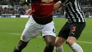 Gelandang Manchester United, Paul Pogba mengontrol bola dari kawalan pemain Newcastle United, Paul Dummett selama pertandingan lanjutan Liga Inggris di St James 'Park (2/1). MU menang 2-0 atas Newcastle. (AFP Photo/Lindsey Parnaby)