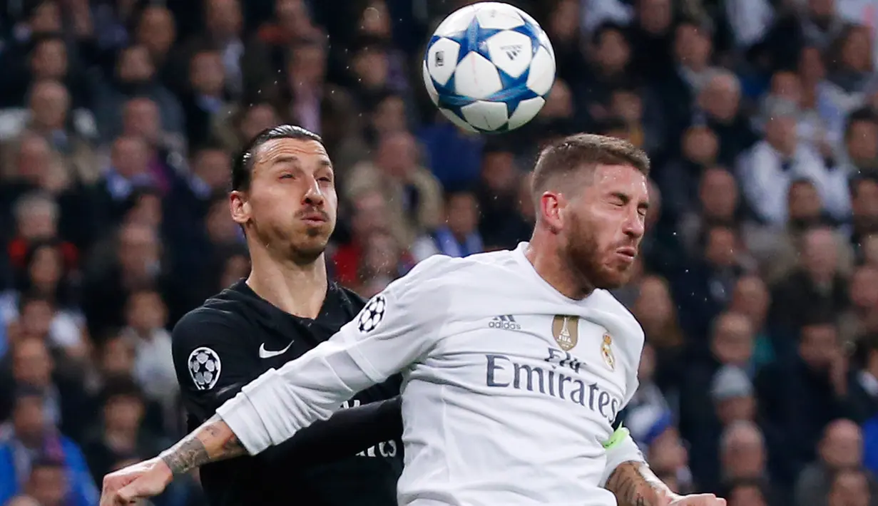 Penyerang Paris St Germain, Zlatan Ibrahimovic (kiri) berebut bola udara dengan bek Real Madrid, Sergio Ramos pada liga champions di stadion Santiago Bernabeu, Madrid, Spanyol (3/11). Real Madrid menang atas PSG dengan skor 1-0. (Reuters/Juan Medina)