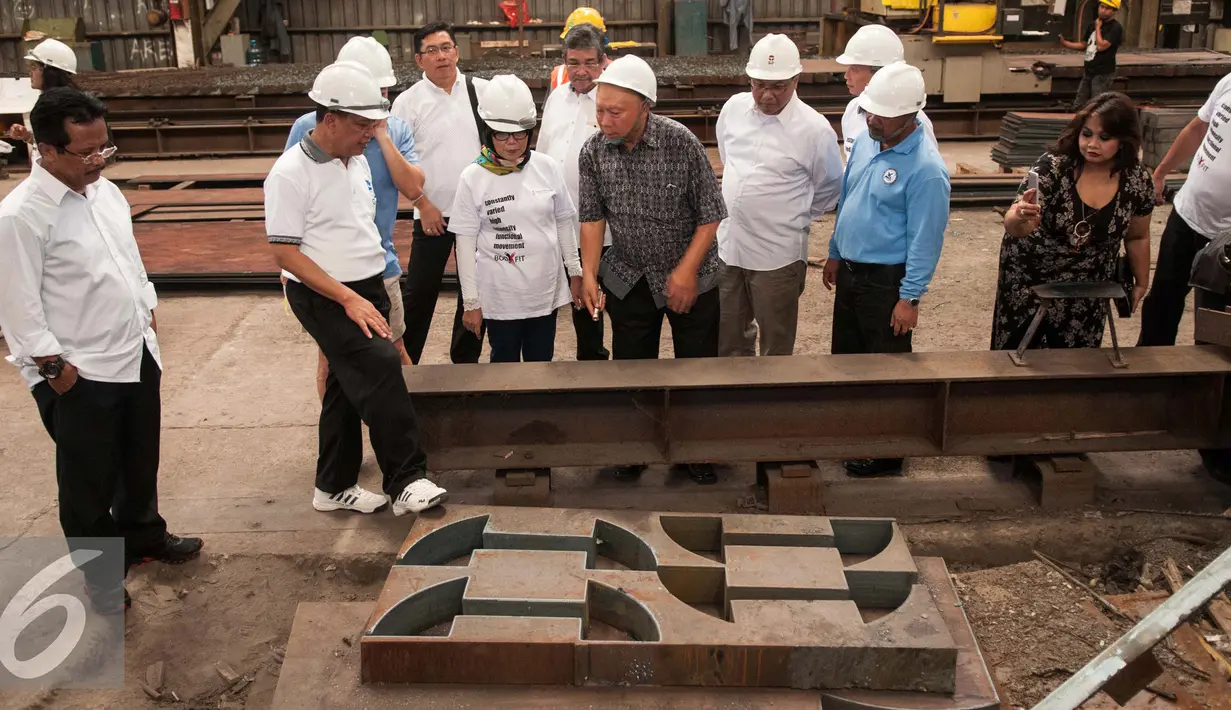 Menristekdikti Muhammad Nasir memeperhatikan pelat baja  di PT Gunung Steel Cikarang, Jawa Barat, Minggu (15/1). Kedatangannya Muhammad Nasir untuk mengecek kesiapan pabrik dalam memproduksi massal Kapal Pelat Datar. (Liputan6.com/Gempur M. Surya)