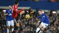 Aksi pemain Everton, Wayne Rooney (kanan) melakukan tembakan melewati adangan pemain Manchester United, Ander Herrera pada lanjutan Premier League di Goodison Park, Liverpool, (1/1/2018). MU menang 2-0. (AFP/Paul Ellis)