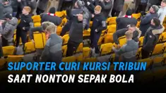 Keduanya menggondol sebuah kursi tribun yang lepas, dengan membelakangi petugas.