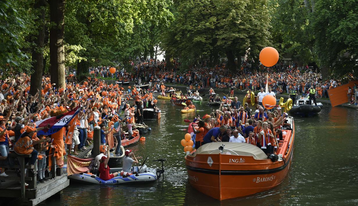 Pemain timnas putri Belanda menggunakan perahu saat parade juara usai meraih trofi Piala Eropa Wanita 2017 di Sungai Utrecht, (7/8/2017). (AFP/John Thys)