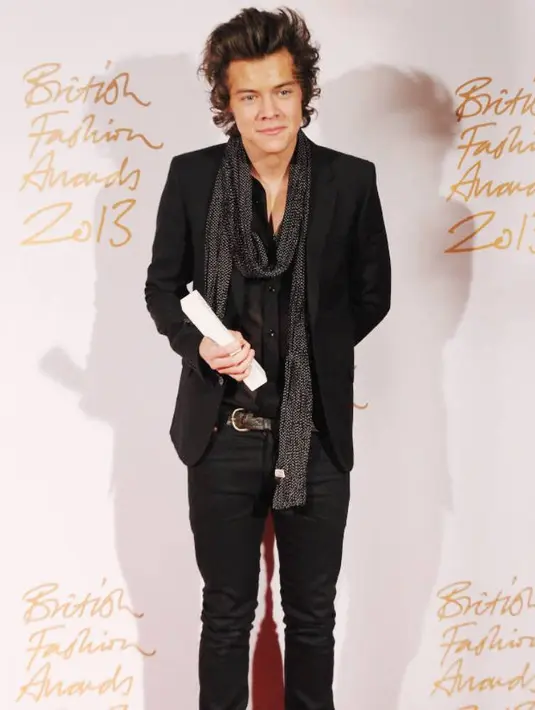 Harry Styles mengalungkan scarf di lehernya saat hadir di British Fashion Awards pada tahun 2013 lalu. Fashionista! (Stuart C. Wilson/Getty Images)