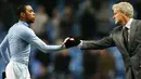 Manchester City's striker Robinho shakes hands with manager Mark Hughes after winning their Premier League football match against Newcastle at the City Of Manchester Stadium in Manchester on January 28, 2009. AFP PHOTO/Glyn Kirk