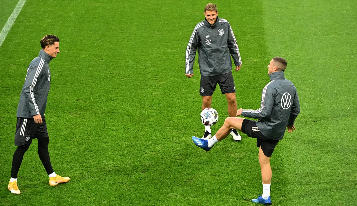 (ki-ka) Bek Jerman Robin Koch, Niklas Stark dan Robin Gosens melakukan pemanasan saat sesi latihan di stadion Rheinenergie, Jerman (9/10/2020). Jerman akan bertanding melawan Turki pada laga persahabatan di stadion Rheinenergie di Cologne, Jerman, Kamis (8/10/2020). (AFP/Ina Fassbender)
