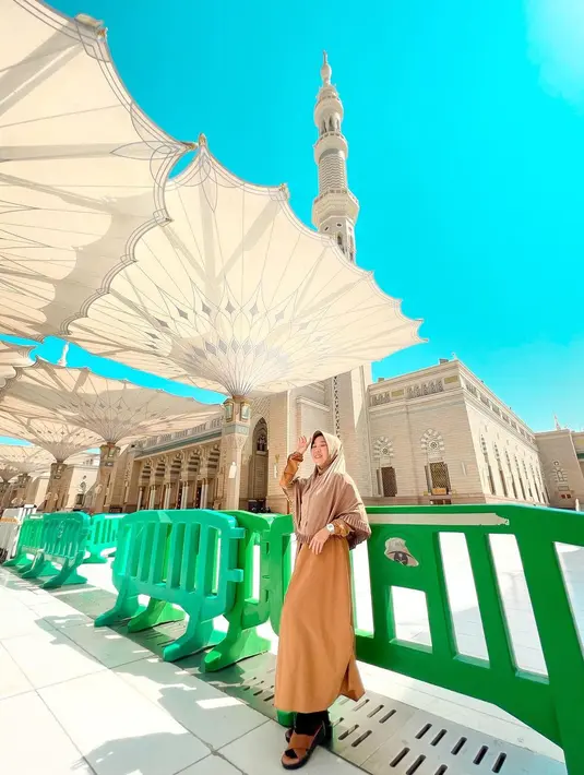 Mantan guru ini berpose di bawah payung khas masjid Nabawi, Madinah. Kiky berharap tahun berikutnya bisa kembali ke Tanah Suci bersama pasangan. (Foto: Instagram/@kikysaputrii)