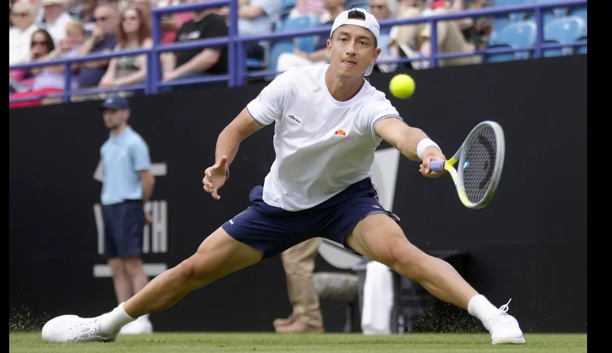 Petenis Inggris, Ryan Peniston berusaha mengembalikan bola menuju petenis Denmark, Holger Rune saat pertandingan tenis tunggal putra di turnamen tenis Eastbourne International di Eastbourne, Inggris, pada Selasa 21 Juni 2022. (AP/Kirsty Wigglesworth)