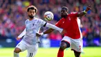 Pemain Liverpool Mohamed Salah (kiri) berebut bola dengan pemain Nottingham Forest Serge Aurier pada pertandingan sepak bola Liga Inggris di City Ground, Nottingham, Inggris, 22 Oktober 2022. Liverpool dikalahkan dengan skor 0-1. (Joe Giddens/PA via AP)