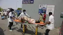 Petugas kesehatan membawa pasien untuk dirawat di rumah sakit pemerintah khusus COVID-19 di Ahmedabad, India, pada Selasa (27/4/2021). Kasus virus corona di India melonjak lebih cepat dari tempat lain di dunia. (AP Photo/Ajit Solanki)