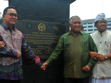 Ketua MPR Zulkifli Hasan bergandeng tangan dengan Ketua Tim Pengarah Siaga Bumi, Din Syamsuddin saat menghadiri peringatan Hari Perdamaian Internasional di Taman Perdamaian, Kompleks Parlemen, Jakarta, Senin (21/9/2015). (Liputan6.com/Johan Tallo)