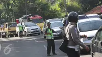 Petugas berusaha mengatur kemacetan kendaraan yang melintas di jalur lingkar Nagreg, Jawa Barat, Sabtu (2/7). Kemacetan disebabkan bus pemudik yang mengalami kecelakaan hingga menutup sebagian jalur. (Liputan6.com/Immanuel Antonius)