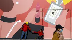Seorang wanita mengenakan masker untuk mencegah penyebaran virus corona di luar toko ritel di pusat perbelanjaan di Beijing, Selasa (3/11/2020). Mayoritas warga Beijing masih mengenakan masker di area luar ruangan bahkan ketika China sebagian besar telah mengendalikan wabah. (AP Photo/Andy Wong)
