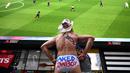 US actor the "Naked Cowboy" watches the 2019 Women's World Cup quarter-final football match between France and the United States on a big screen in Times Square in New York on June 28, 2019. (Photo by TIMOTHY A. CLARY / AFP)