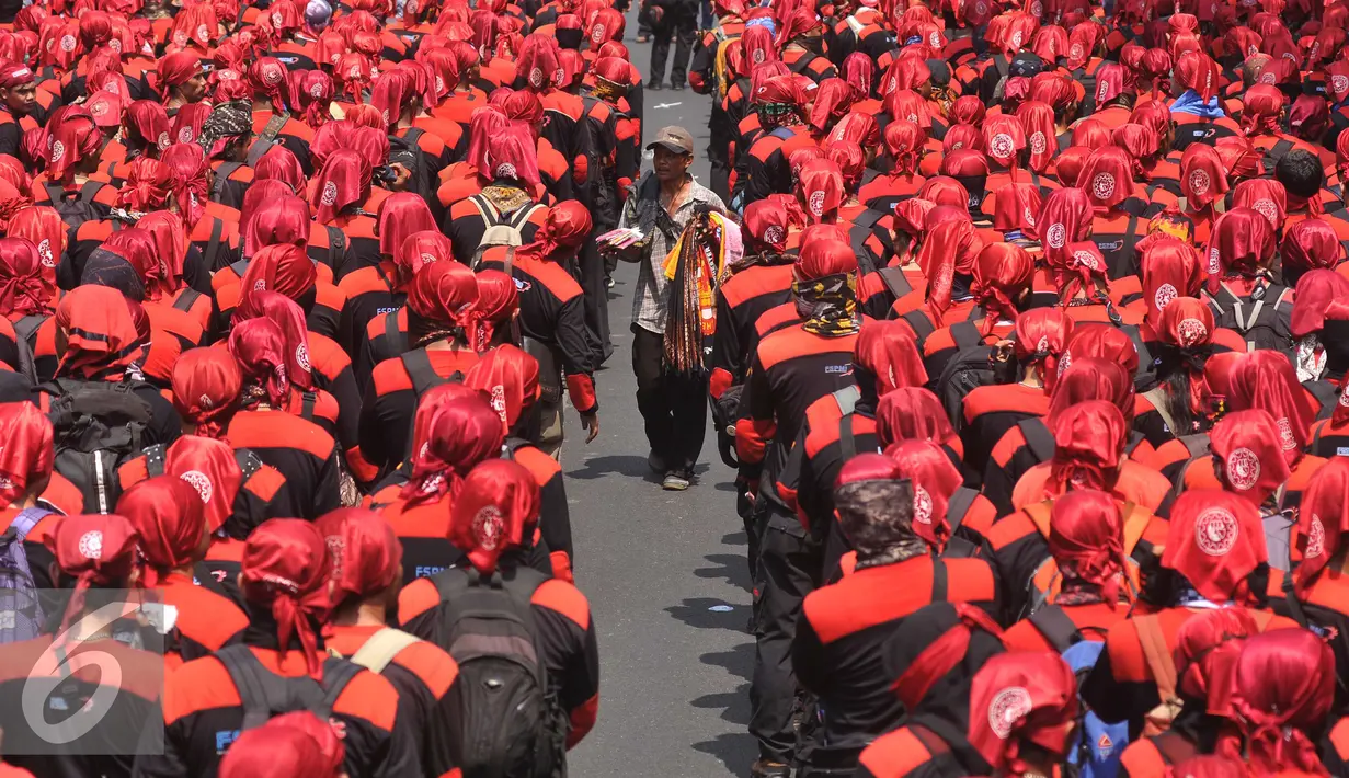 Seorang pedangang berjualan ditengah demo buruh berlangsung, Jakarta, Kamis (29/10/2015). Buruh menuntut agar Presiden Joko Widodo mencabut Peraturan Pemerintah Nomor 78 Tahun 2015 tentang Pengupahan. (Liputan6.com/Gempur M Surya)