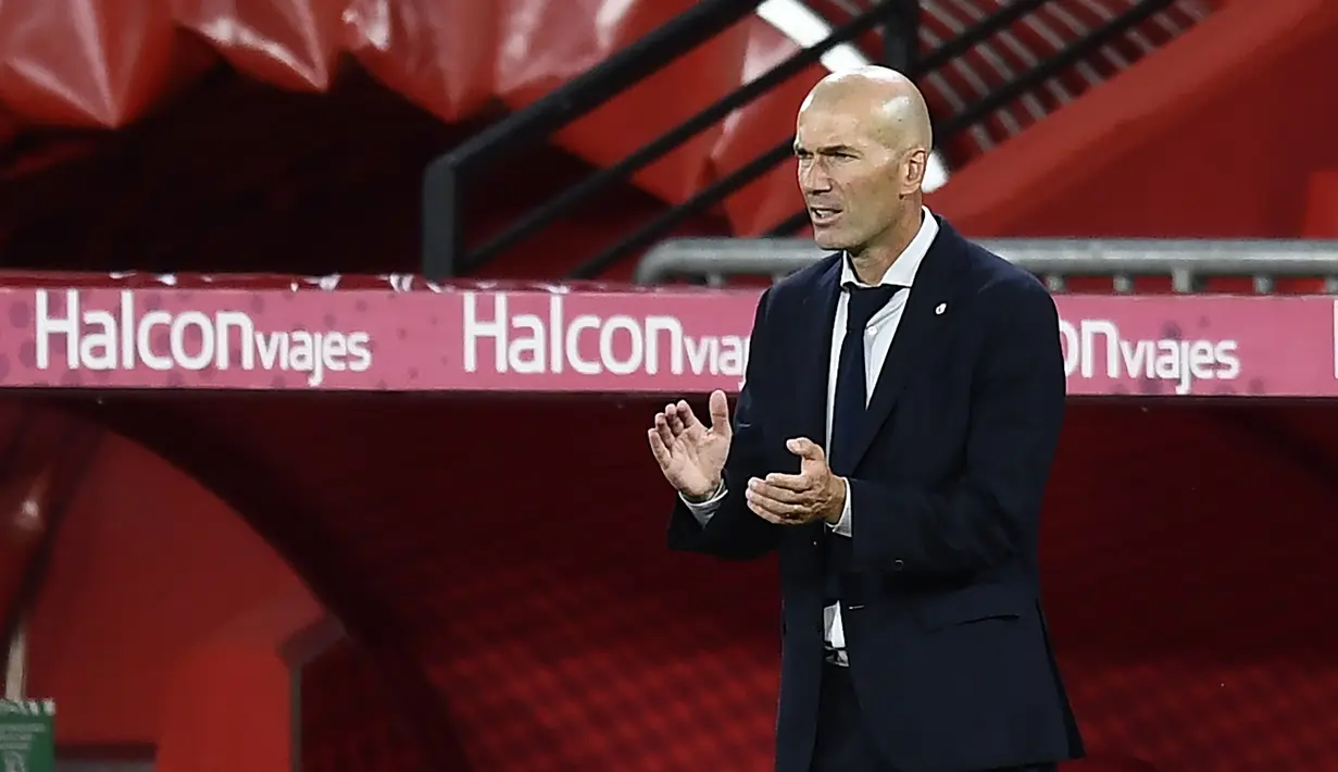 Pelatih Real Madrid, Zinedine Zidane, memperharikan pemainnya saat melawan Granada pada laga lanjutan La Liga pekan ke-36 di di Estadio Nuevo Los Carmenes, Selasa (14/7/2020) dini hari WIB. Real Madrid menang 2-1 atas Granada. (AP/Jose Breton)