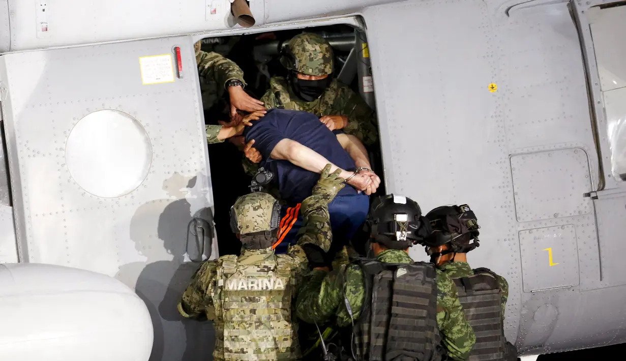 Tentara Meksiko mengawal gembong narkoba Joaquin "El Chapo" Guzman naik ke helikopter sebelum memberikan keterang kepada media di Mexico City, (8/1/2016). (REUTERS/Tomas Bravo)