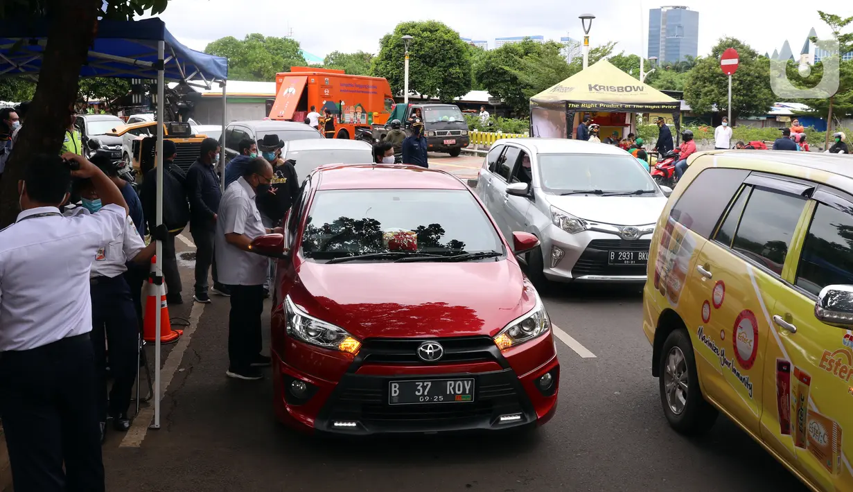 Antrean pengendara mobil saat uji emisi gratis di Jakarta Barat, Rabu (13/1/2021). Dinas Lingkungan Hidup DKI Jakarta mengumumkan kendaraan yang tidak mengikuti uji emisi atau tidak lulus uji emisi gas buang akan dikenakan disinsentif tarif parkir yang tinggi dan tilang. (Liputan6.com/Angga Yuniar)