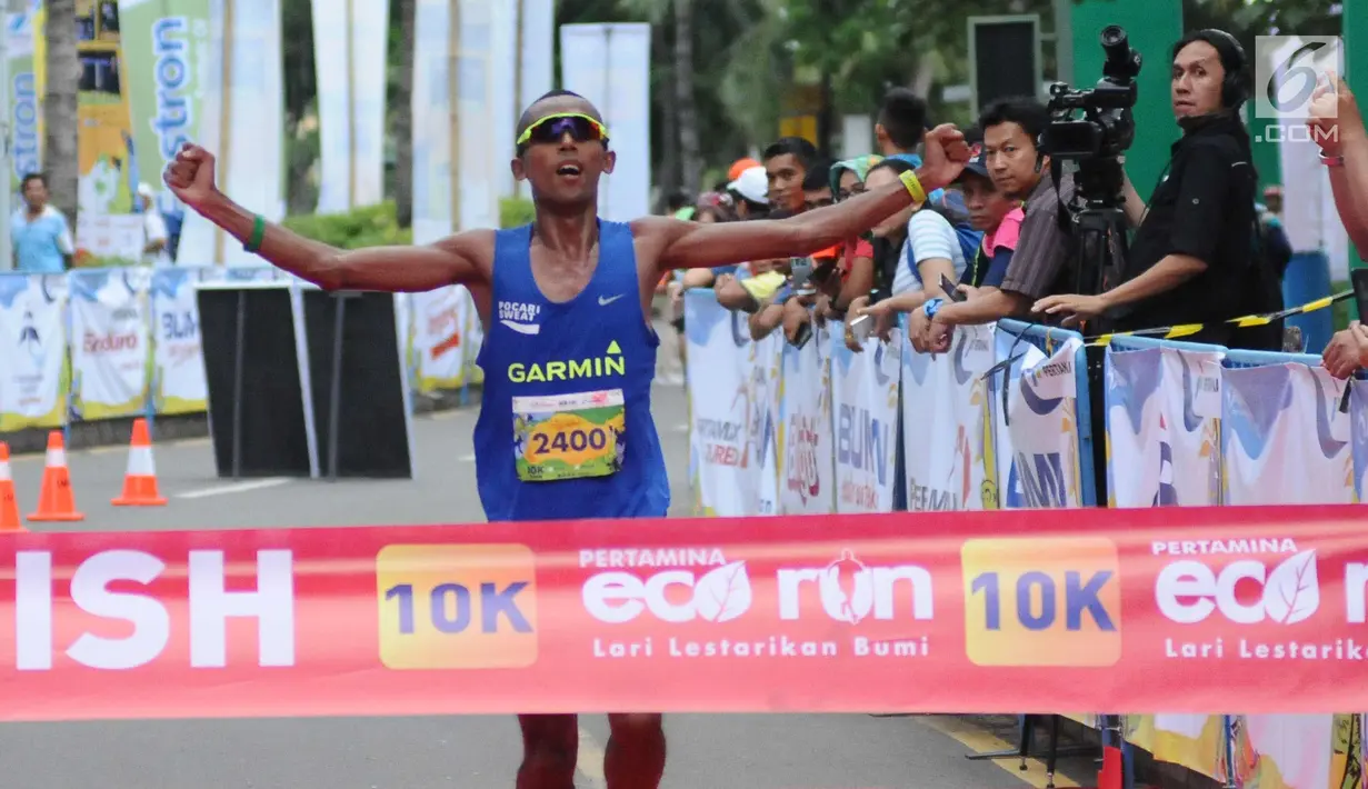 Pelari nasional, Agus Prayogo membentangkan tangan jelang finish pertama di ajang Pertamina Eco Run 2017 kategori 10K umum pria di Pantai Karnaval Ancol, Jakarta, Sabtu (16/12). Agus mendapat hadiah tunai 15 juta rupiah. (Liputan6.com/Helmi Fithriansyah)