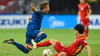 Bek Timnas Thailand, Theerathon Bunmathan ditekel oleh pemain Timnas Vietnam di Piala AFF 2020. (AFP/Roslan RAHMAN).