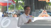 Jokowi bersama istrinya Iriana datang ke TPS 27 Menteng, Jakarta Pusat pukul 08.00 WIB, Rabu (9/4/2014) (Liputan6.com/Herman Zakharia)