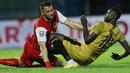 Striker Persija Jakarta, Marko Simic (kiri) saling dorong dengan striker Bhayangkara Solo FC, Ezechiel N'Douassel, pada laga Piala Menpora 2021 di Stadion Kanjuruhan, Malang, Rabu (31/3/2021). Persija Menang dengan skor 2-1. (Bola.com/M Iqbal Ichsan)