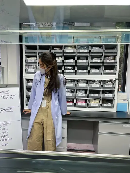 Kembali ke laboratorium, Nong Poy terlihat mengenakan outfit cokelat dengan tali. Dan tentu saja jas lab kebanggaannya. [@poydtreechada]