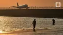 <p>Wisatawan mengunjungi objek wisata Pantai Kelan dengan latar belakang pesawat yang mendarat di Tuban, Badung, Denpasar, Kamis (5/5/20222). Kunjungan wisatawan domestik (Wisdom) ke Pulau Bali, saat libur Lebaran Idul Fitri tahun 2022 terus meningkat. Per hari kedatangan wisdom rata-rata 40 ribu. (merdeka.com/Arie Basuki)</p>