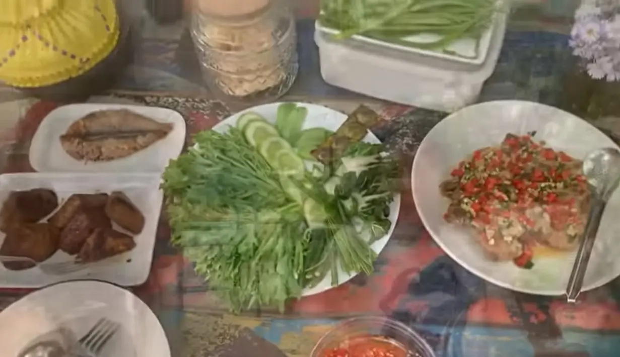 Drummer grup Slank itu tampak bersama keluarga  makan di halaman rumah yang tampak asri. Tampak, beberapa menu sederhana tersaji di atas meja tertata rapi. Selin ada bebberapa lauk ayam, ikan, tapi juga ada beberapa lalapan. [Youtube/ALZ Family Bimbim Slank]